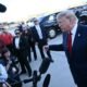 Donald Trump fala com jornalistas diante de câmeras e microfones